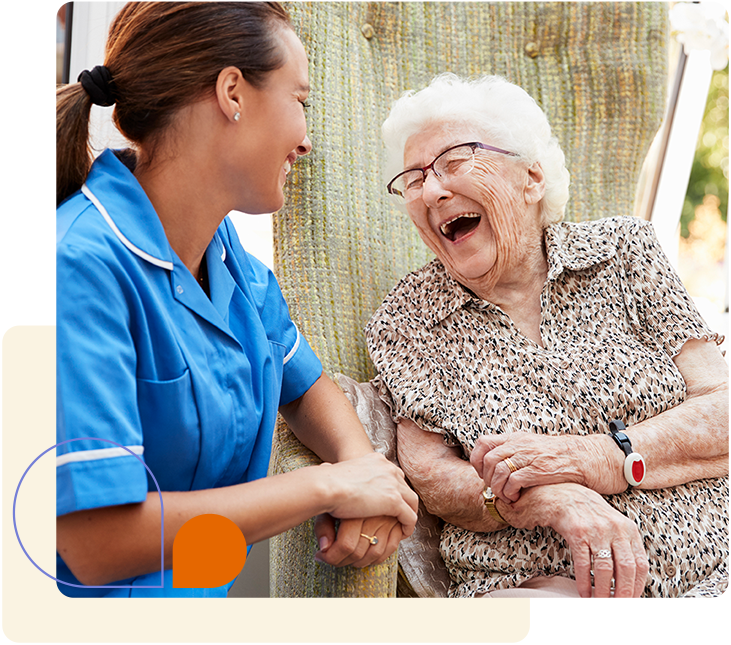 An aging and adult services nurse laughing with an elderly woman in a retirement home.