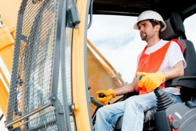 Worker operating a crane at a construction site